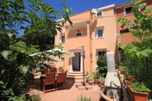 a house with a patio in front of it at Apartments with a parking space Cunski, Losinj - 8010 in Cunski