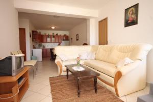 a living room with a couch and a table at Apartments with a parking space Cunski, Losinj - 8010 in Cunski