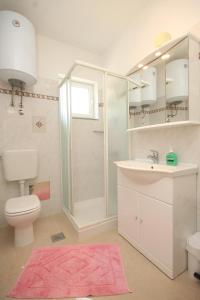a bathroom with a toilet and a sink and a shower at Apartments with a parking space Opatija - Pobri, Opatija - 7918 in Volosko
