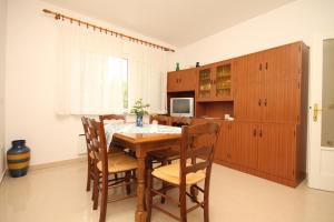 a dining room with a wooden table and chairs at Apartments with a parking space Opatija - Pobri, Opatija - 7918 in Volosko