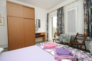 a bedroom with a bed and a closet at Double Room Mali Losinj 7953a in Mali Lošinj