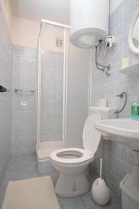 a bathroom with a toilet and a sink and a shower at Double Room Mali Losinj 7953a in Mali Lošinj