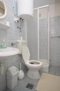 a bathroom with a toilet and a sink and a shower at Double Room Mali Losinj 7953b in Mali Lošinj