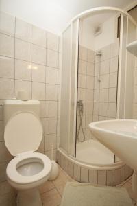 a bathroom with a toilet and a shower and a sink at Studio Mali Losinj 7953b in Mali Lošinj