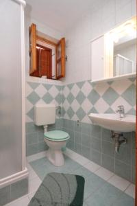 a bathroom with a toilet and a sink at Apartments by the sea Osor, Losinj - 8088 in Nerezine