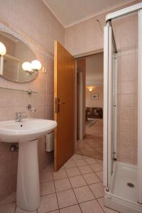 a bathroom with a sink and a shower at Apartments by the sea Mali Losinj (Losinj) - 7974 in Mali Lošinj