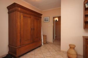 a room with a wooden cabinet and a hallway at Apartments by the sea Mali Losinj (Losinj) - 7974 in Mali Lošinj