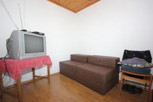 a living room with a couch and a tv at Apartments by the sea Zaglav, Dugi otok - 8191 in Sali
