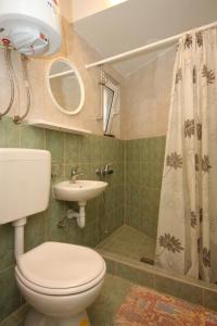 a bathroom with a toilet and a sink and a shower at Seaside holiday house Unesic - Unije, Losinj - 8045 in Unije