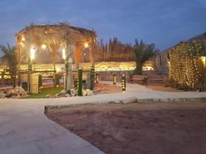 a pavilion with lights in a park at night at استراحة لبنان ا في بنبان Istraha in Riyadh