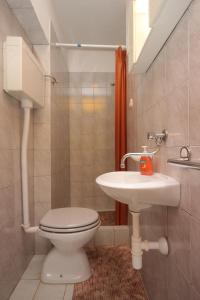 a bathroom with a toilet and a sink at Apartments with a parking space Sali, Dugi otok - 910 in Sali