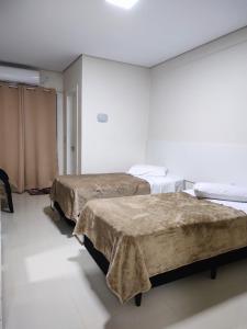 Een bed of bedden in een kamer bij Hotel Pousada Friedenau