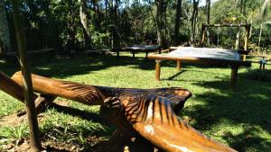 a park with a bench and a swing at Pousada Hang Conectada com a Natureza in Florianópolis