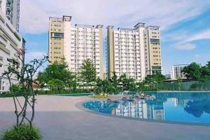 an image of an apartment building with a swimming pool at Minimalist Cozy Condo Studio Unit in Grand Residences Cebu in Cebu City