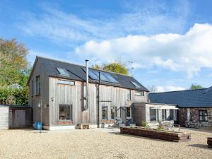 a barn style house with a metal roof at The Woodshed in Sheepwash