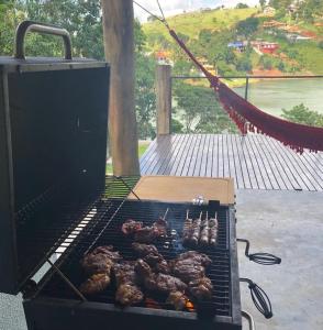 a grill with a bunch of meat on it at Igarata Cabana da Sol in Igaratá