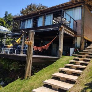 a house with stairs leading up to a porch at Igarata Cabana da Sol in Igaratá +13 photos