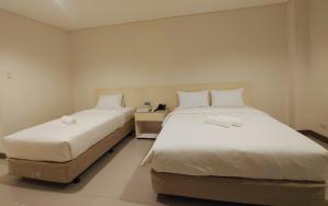 Ένα ή περισσότερα κρεβάτια σε δωμάτιο στο Kaizen Suites