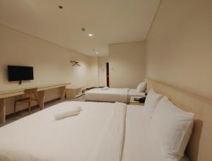 Ένα ή περισσότερα κρεβάτια σε δωμάτιο στο Kaizen Suites