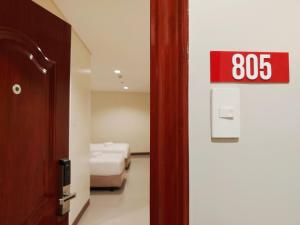 Ένα ή περισσότερα κρεβάτια σε δωμάτιο στο Kaizen Suites
