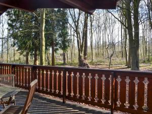 a wooden fence with a bench on a wooden deck at Ludensian Lodge - Uk37186 in Legbourne