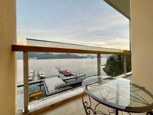 a balcony with a glass table and a view of the water at Ming Hu B&B in Yuchi