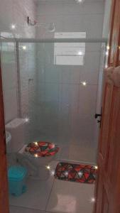 a bathroom with a shower with lights on the floor at Villa Dedeus in Uruçuca