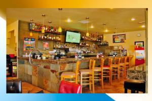 a bar with a bunch of stools in a restaurant at Gold Canyon Golf Resort in Gold Canyon