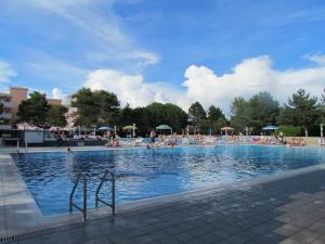 a large swimming pool with many people in it at Appartamenti Valbella in Bibione