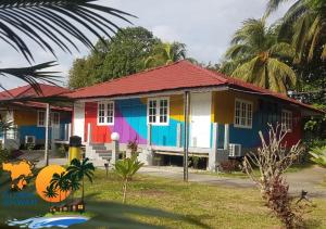 a house painted in different colors on a street at GLOBAL IKHWAN RESORT in Kuah