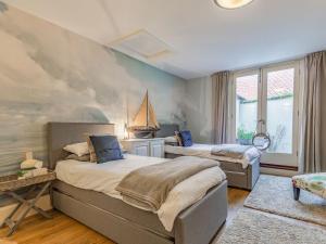 a bedroom with two beds and a painting on the wall at The Bath House in Cromer