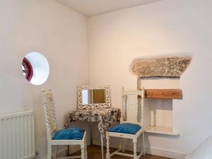 a room with two chairs and a mirror at Barn 2 in Ulverston