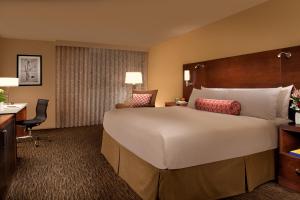 a hotel room with a large bed and a desk at The McCormick Scottsdale in Scottsdale