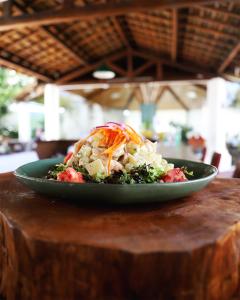 a green plate of food on a wooden table at Blue Tree Towers São Luis in São Luís