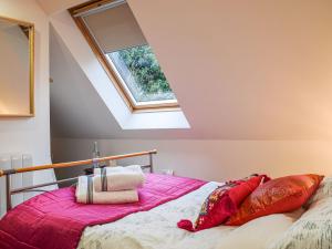 a bedroom with a bed with a pink blanket at Loftings in Hendred