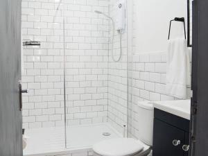 a white bathroom with a shower and a toilet at Merrick - Uk34536 in Newton Stewart