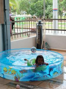 a little girl swimming in a pool at a water park at Rumah Singgah in Pantai Remis