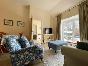 a living room with a couch and a chair and a window at Farr Out in Farr