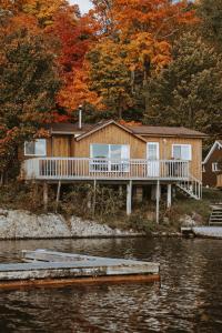 a house on a dock next to a body of water at Lang Lake Resort in Espanola
