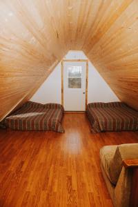 a living room with two couches in the attic at Lang Lake Resort in Espanola