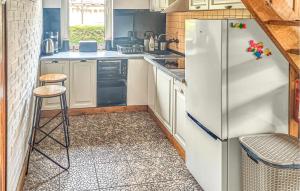 a kitchen with a refrigerator and a stool in it at Stunning Home In Rowy With 5 Bedrooms And Wifi in Rowy