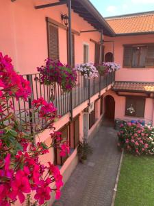 a balcony of a house with pink flowers on it at La Corte Albergo in Desio