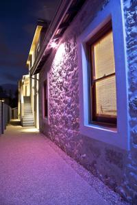 a purple building with a window at night at Fremantle Boutique Accommodation - Maand Up in Fremantle