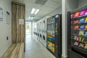 a laundromat aisle with washing machines in a store at Brickell Beauty in Miami