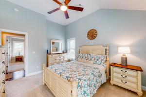 a bedroom with a bed and a ceiling fan at Coastal Serenity - Unit A - Top Floor in Kill Devil Hills