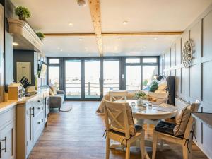 a kitchen and living room with a table and chairs at Riverview Lodge - Uk36550 in Ashleworth