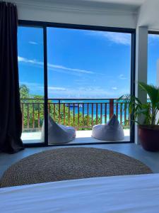 a bedroom with a bed with a view of the ocean at Samura Panorama Guest House in Thulusdhoo