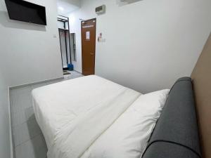 Postel nebo postele na pokoji v ubytování Gemilang Hotel Klang