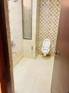 a bathroom with a toilet and a shower at Hotel Narmada in Lāchharas