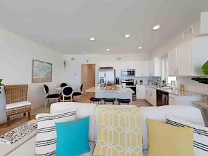 a kitchen and living room with a couch and chairs at Sea Glass #201 in Gulf Shores